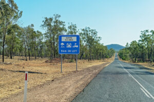 Road signs lead to rest areas with parking.