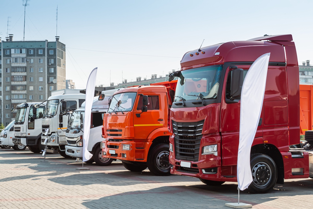 Semi-trucks lined up at a show.